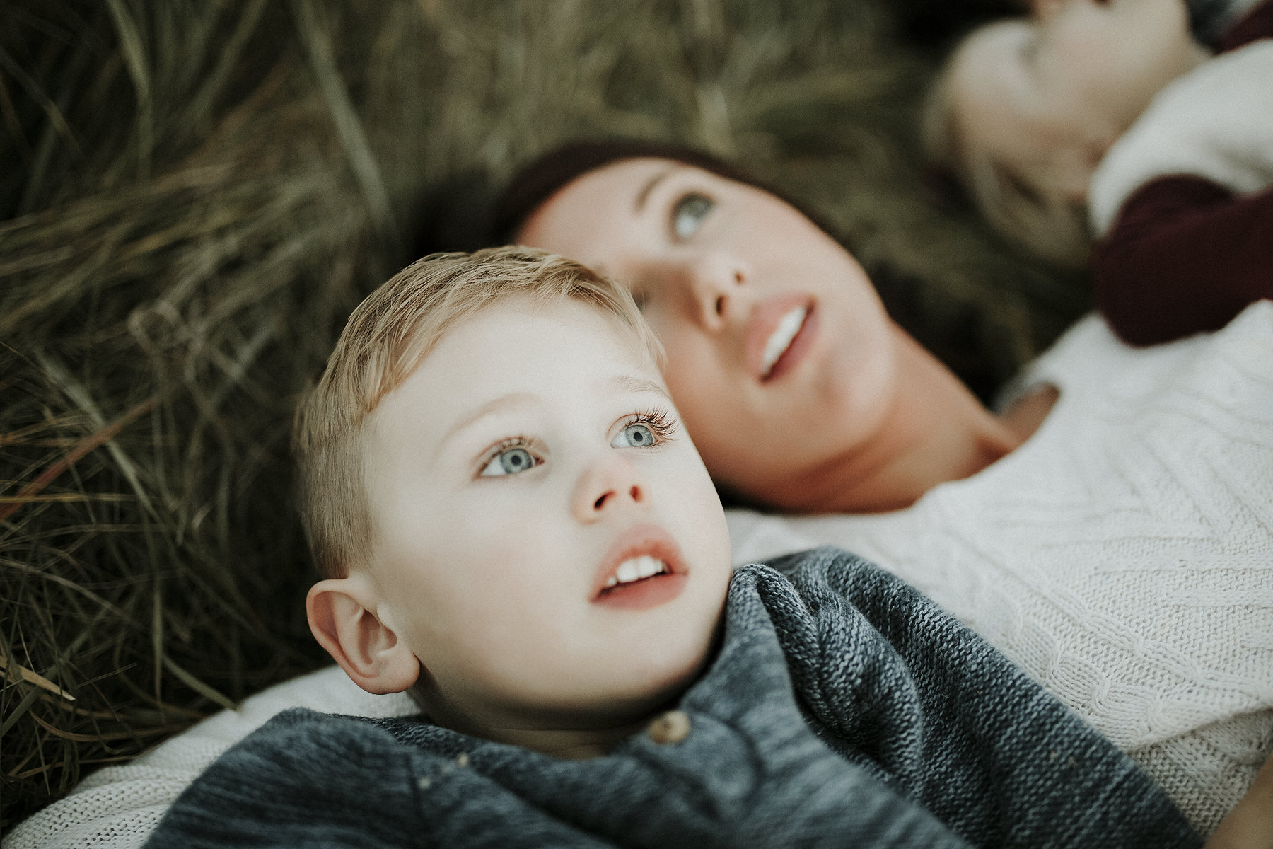 mother-and-son-laying-in -tall-grass-