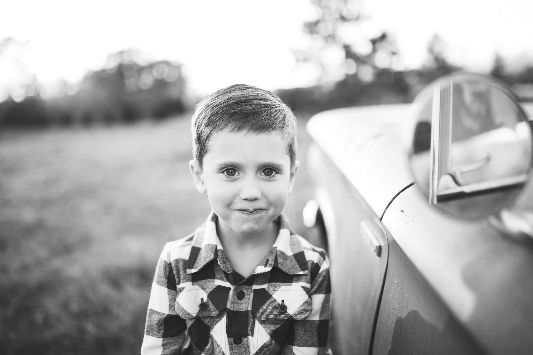 boy-wants his picture taken by classic car
