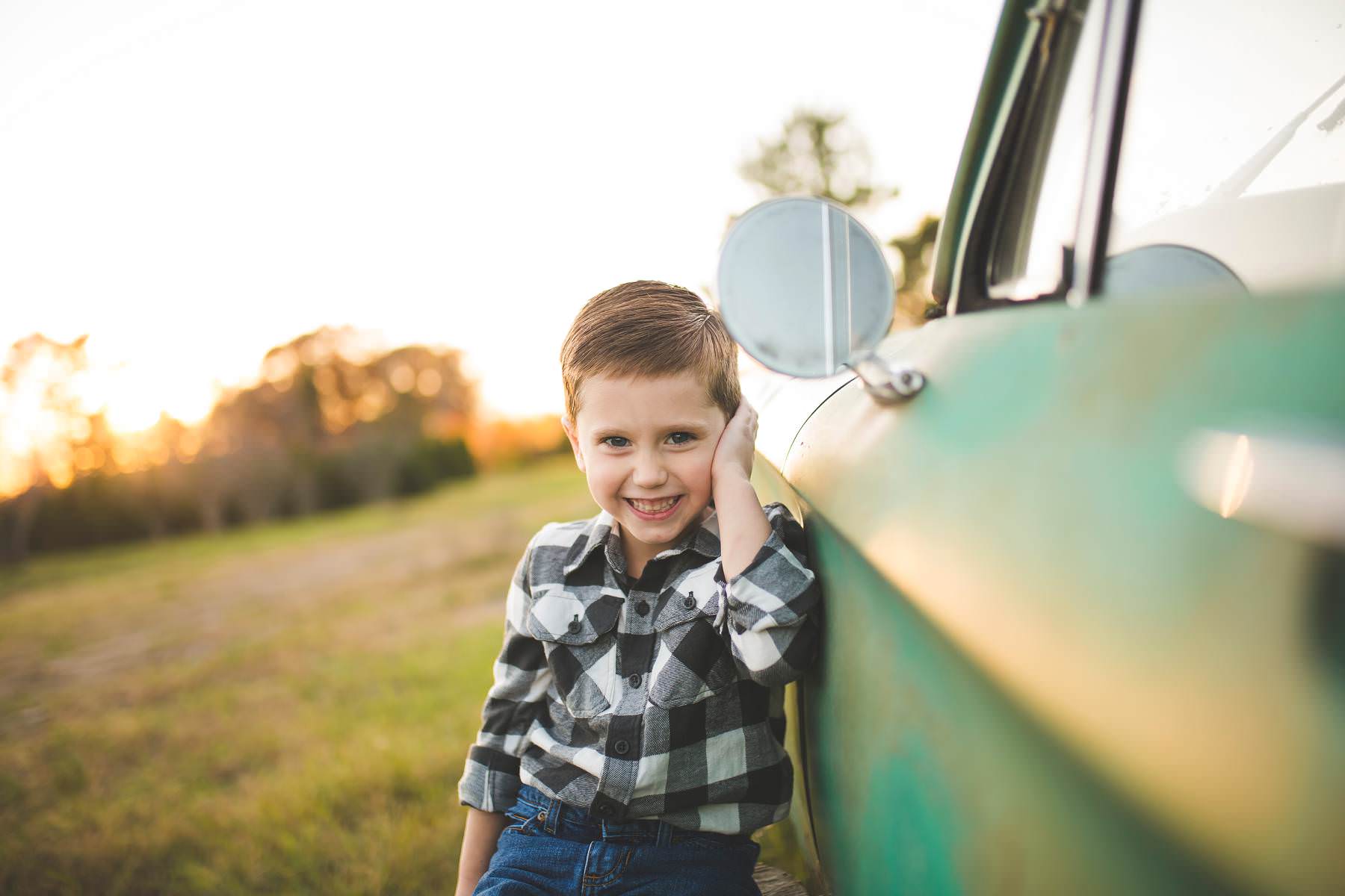 boy-wants his picture taken by classic car