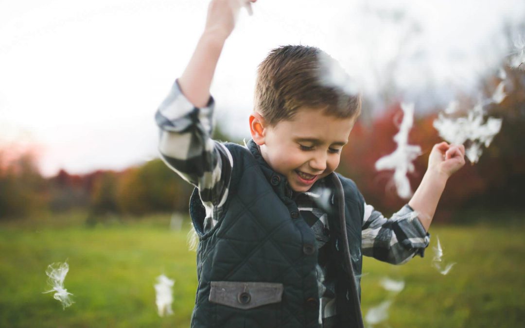 boy plays at sunset on old tree farm