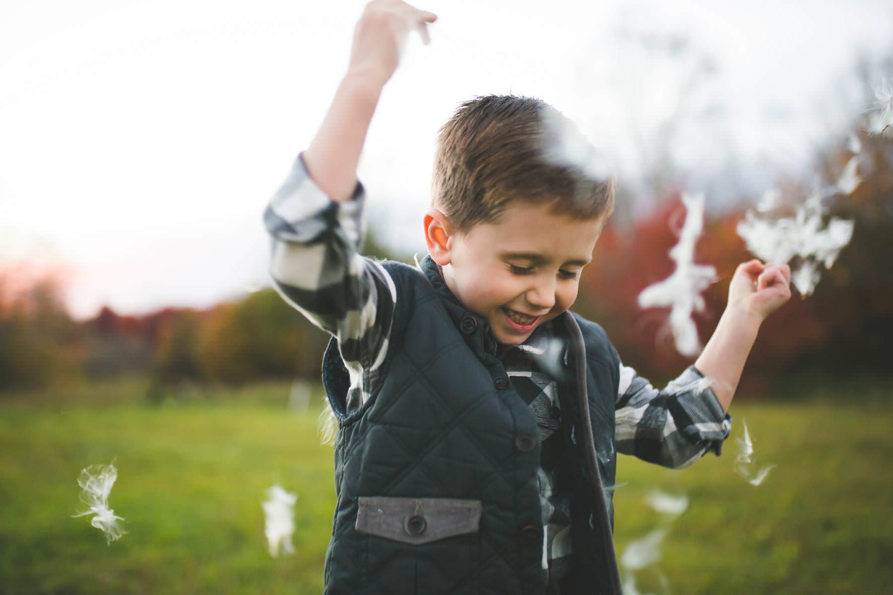 boy plays at sunset on old tree farm