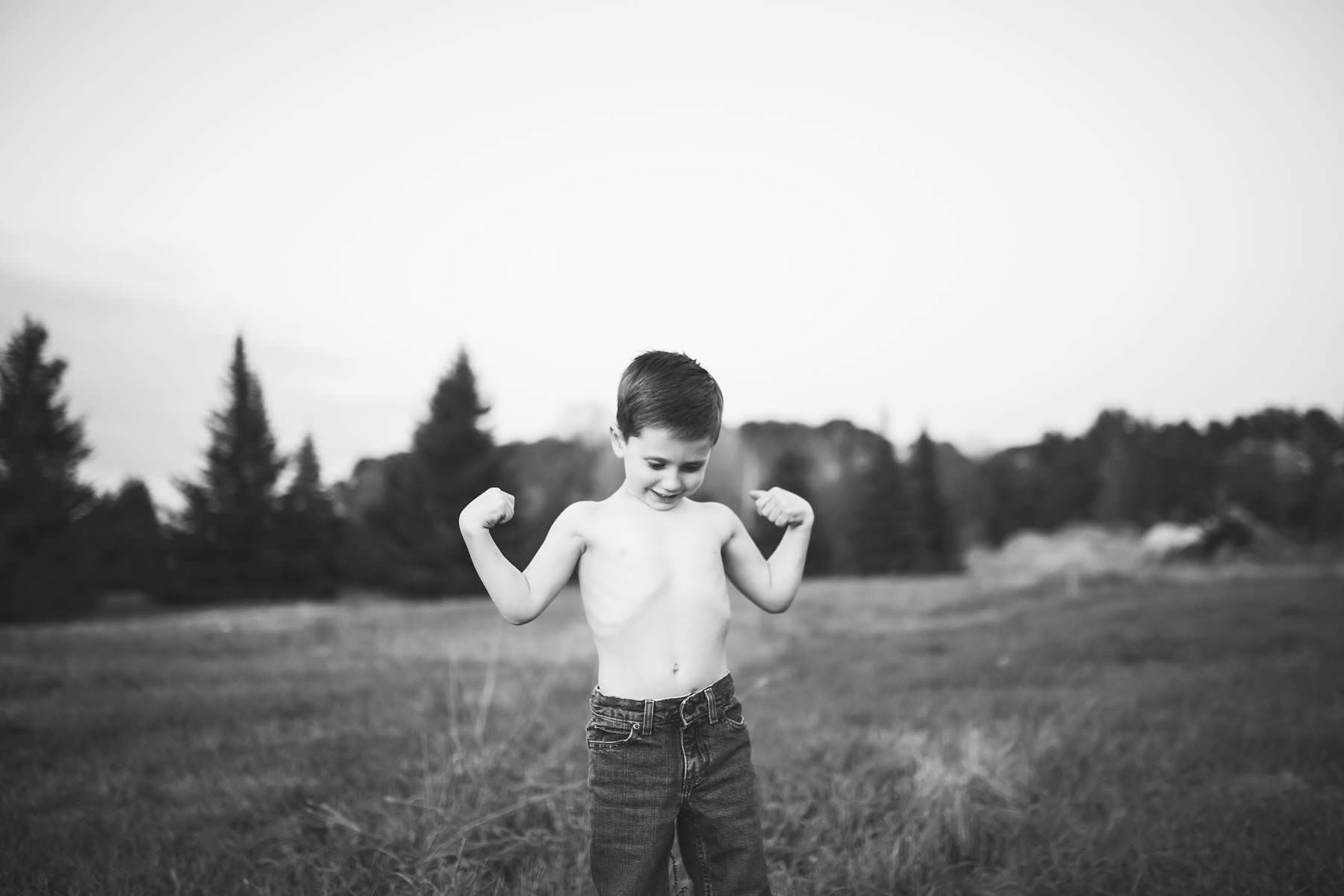 boy plays at sunset on old tree farm