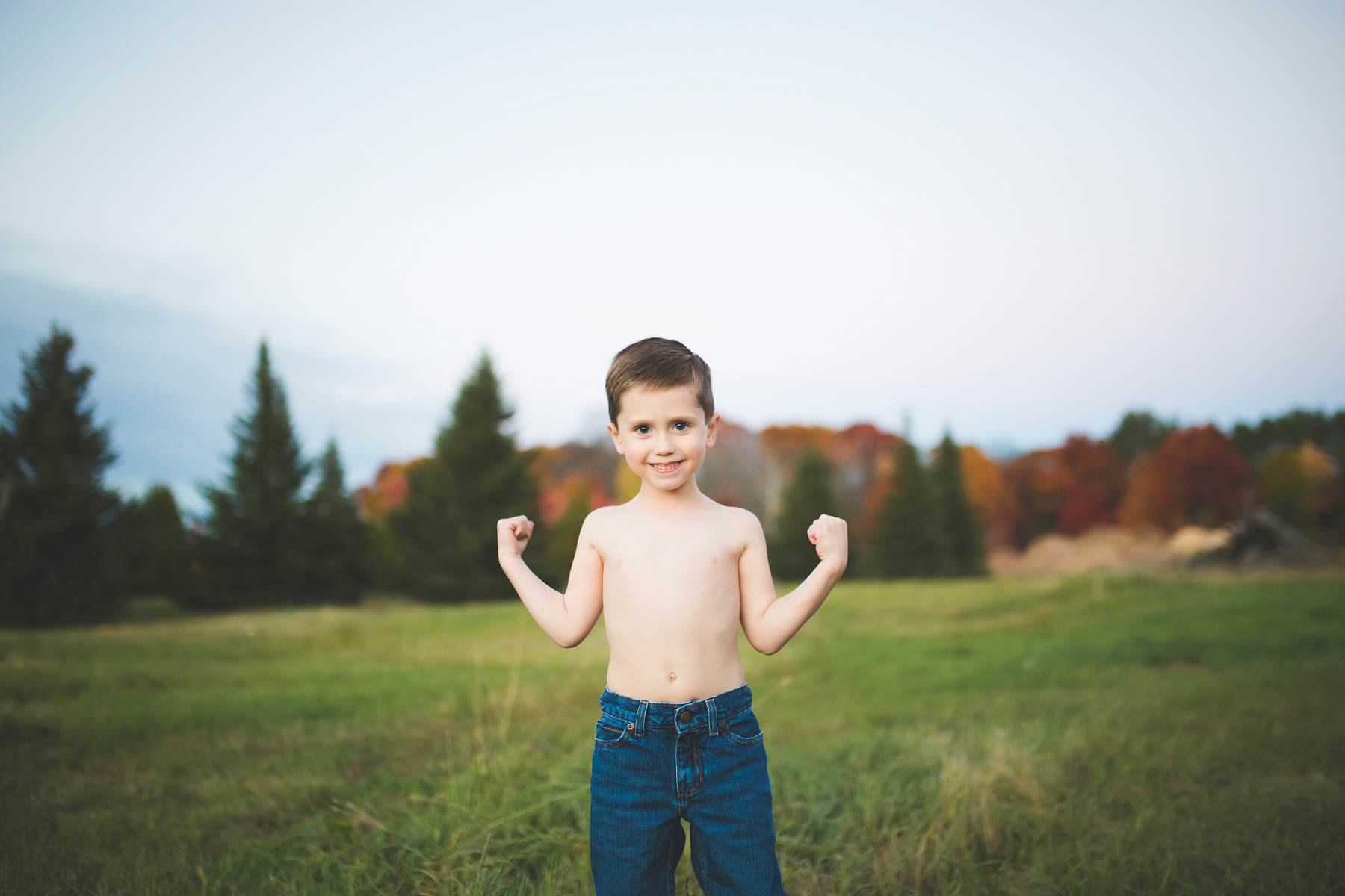 boy plays at sunset on old tree farm