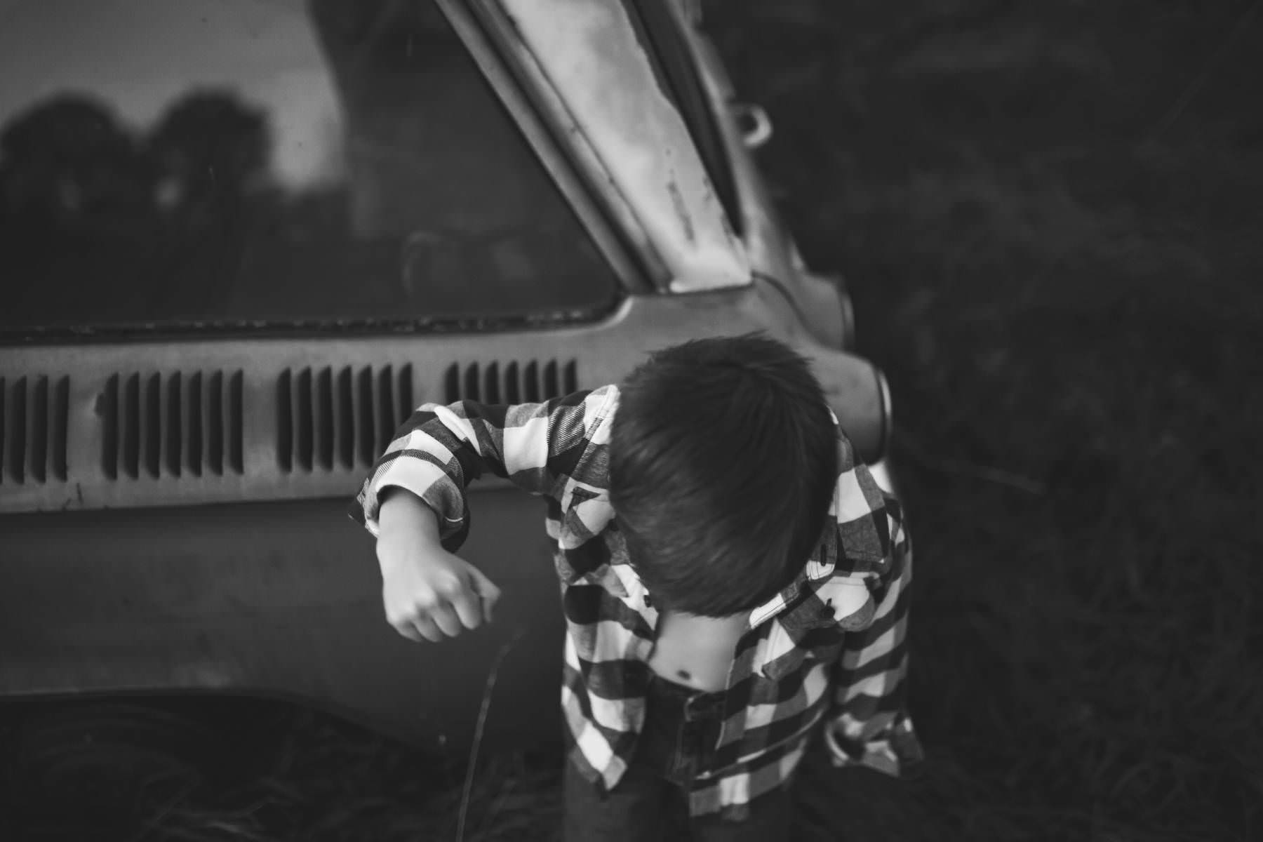 boy-wants his picture taken by classic car