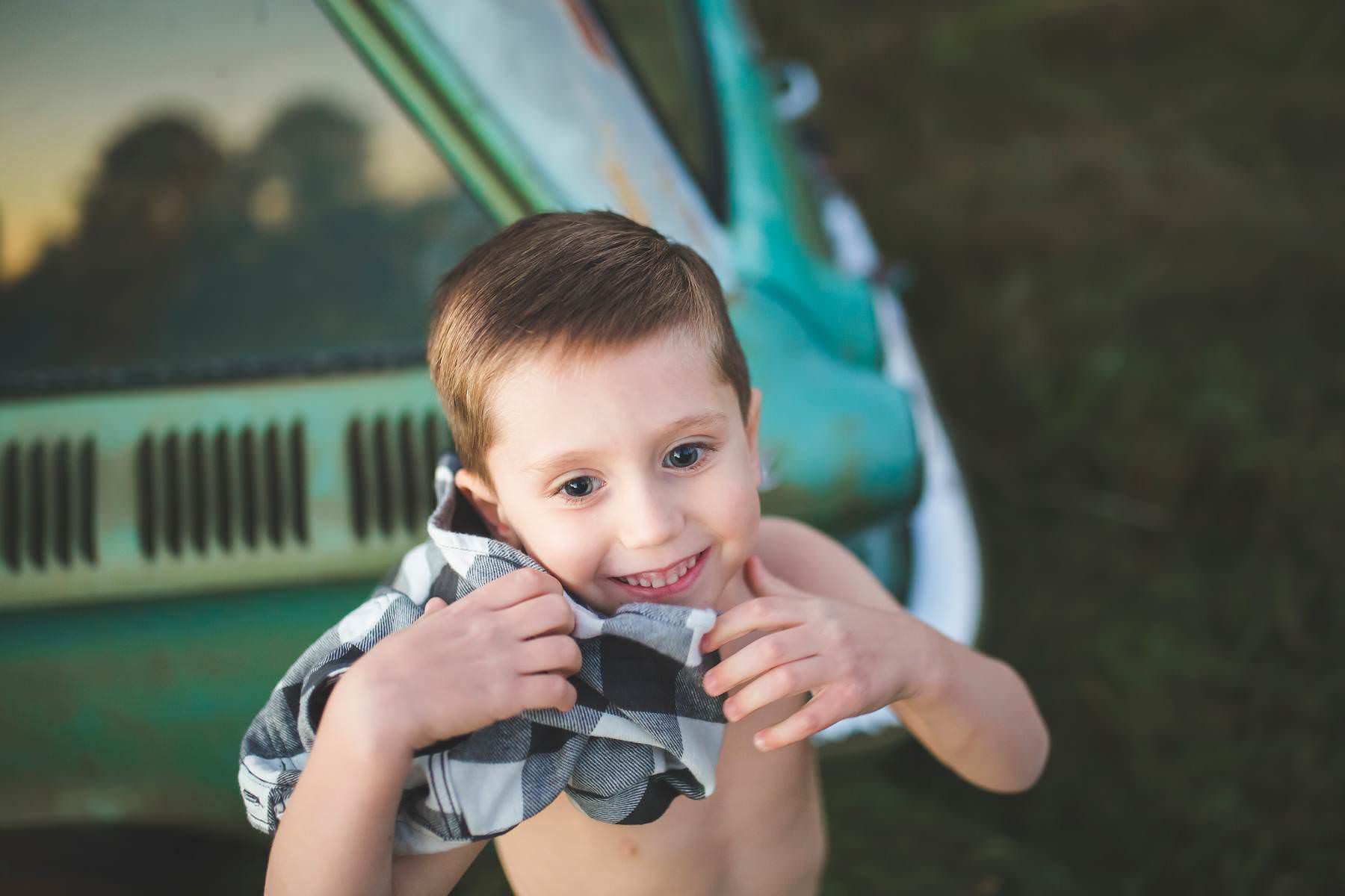boy-wants his picture taken by classic car