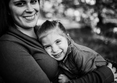 toddler rests on moms chest and smiles