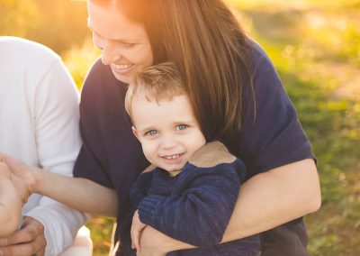 mom holds son tight tree farm