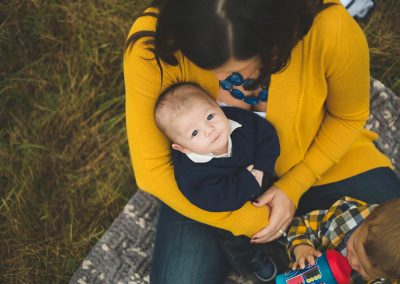 infant is safe in moms arms yellow cartigan