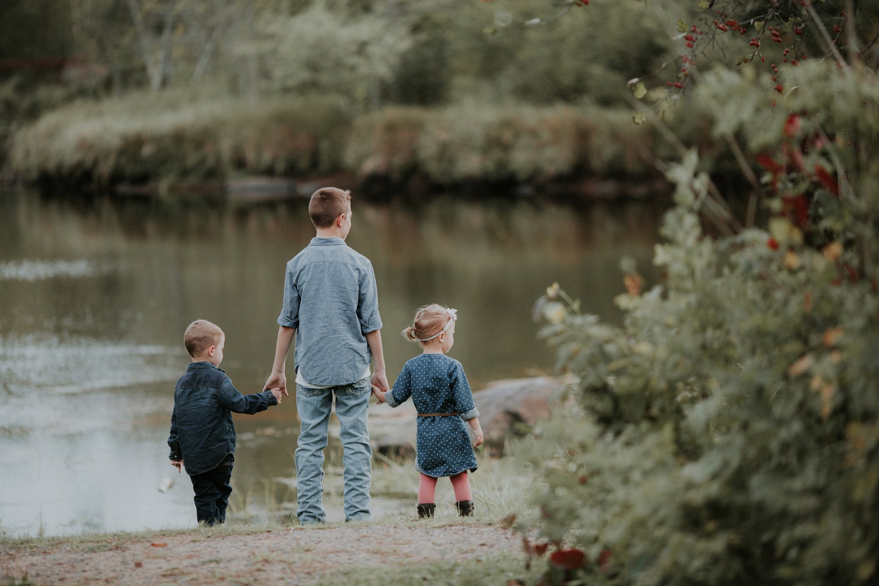 family plays together by river at banning state park