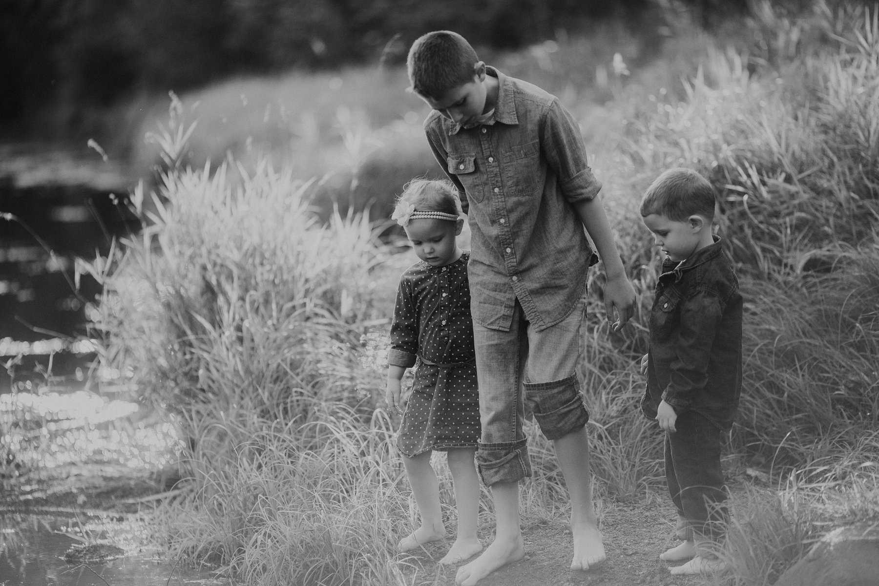 family plays together by river at banning state park