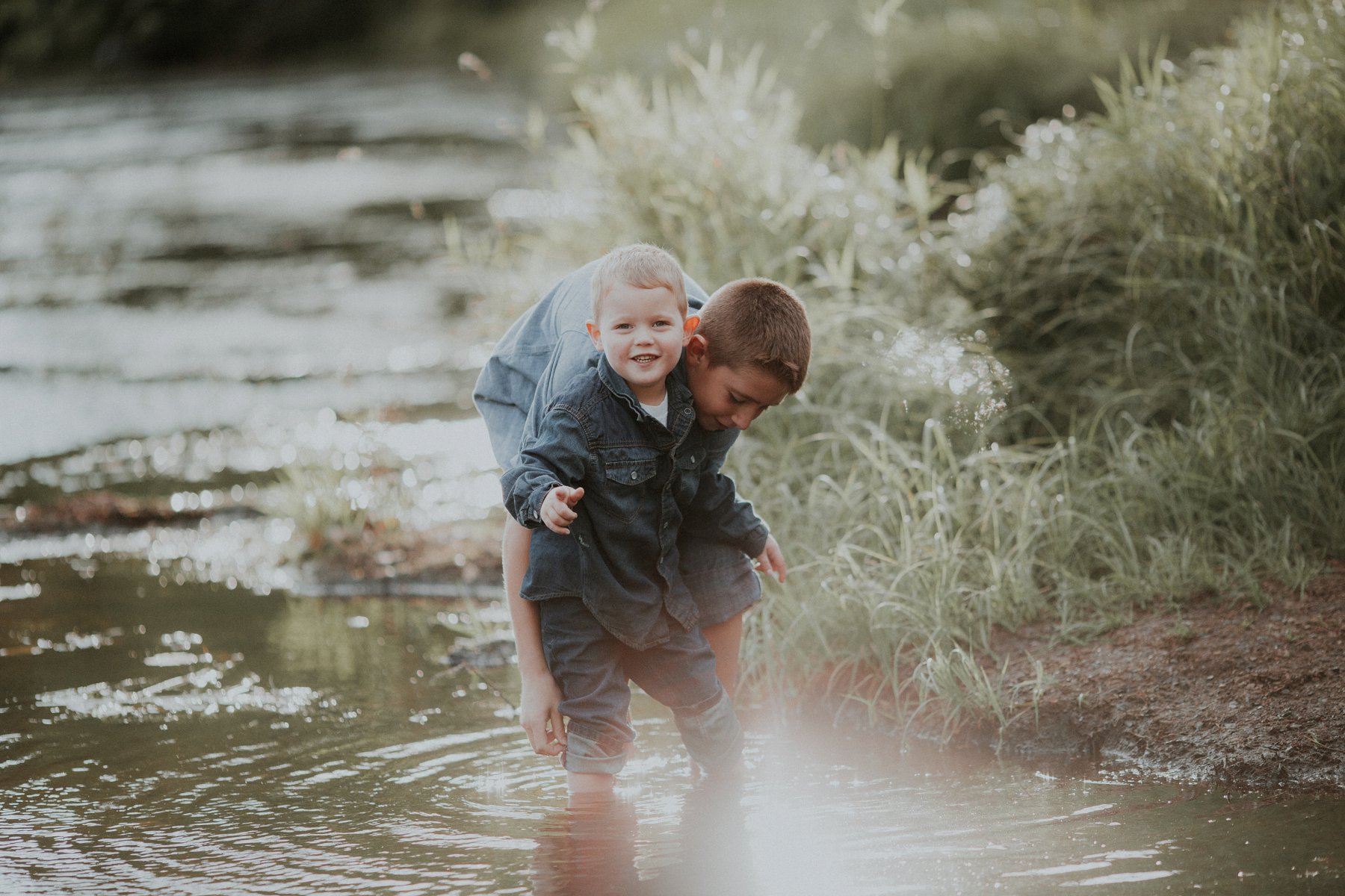 family plays together by river at banning state park