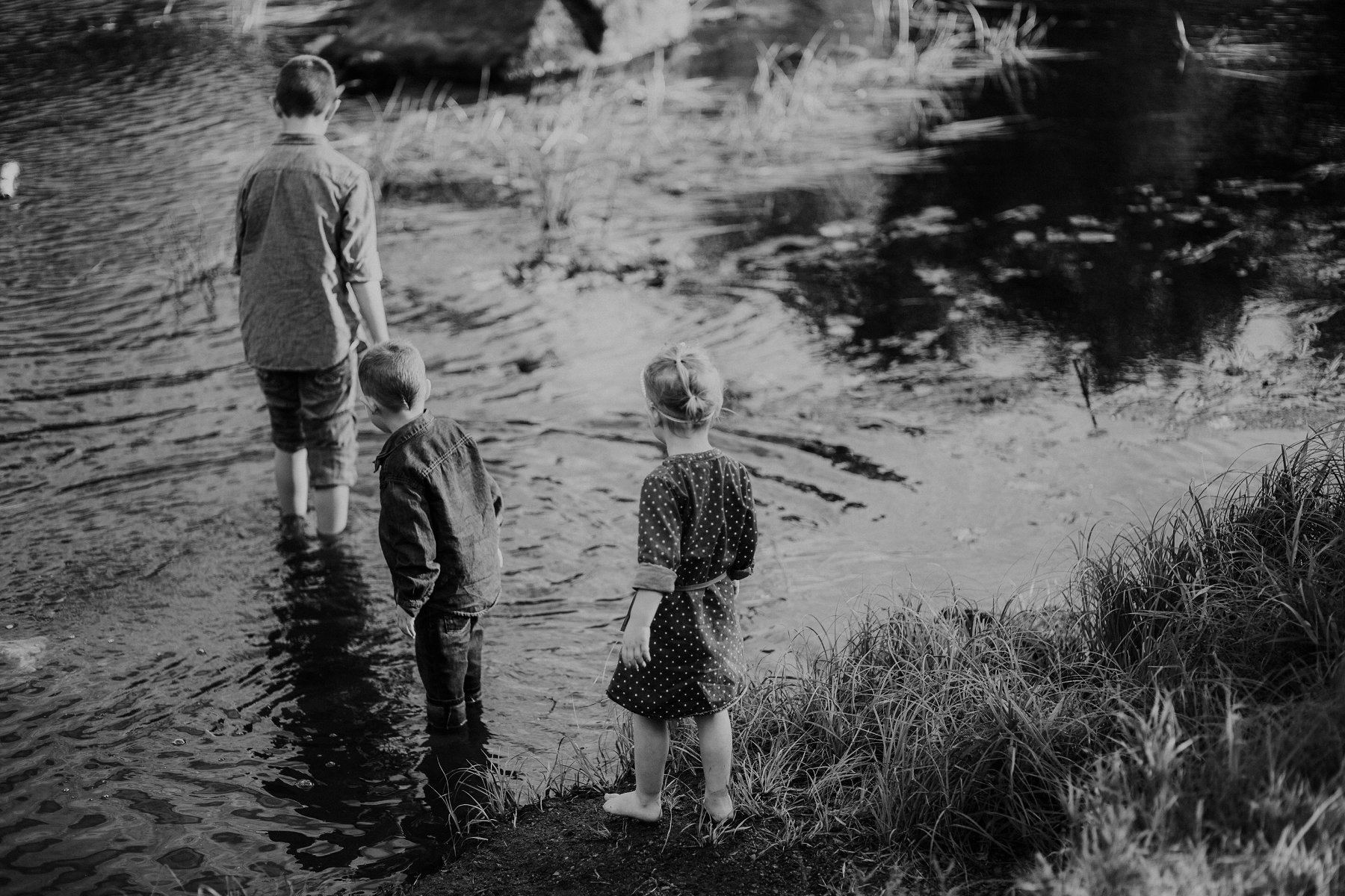 family plays together by river at banning state park