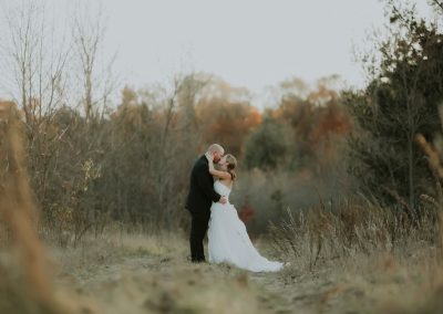 bride and groom in field a minnesota fall