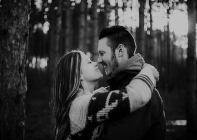 engaged couple kissing in tall pines north branch minnesota